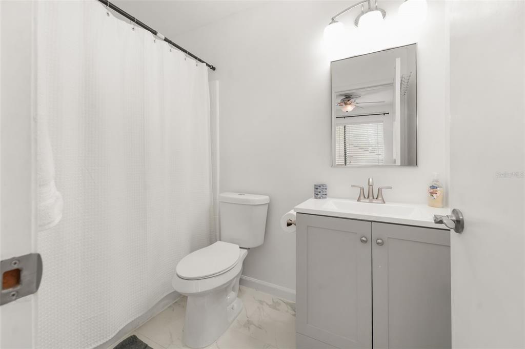 2735 Southwest 35th Place, Unit 903 Gainesville, FL 32608 - Photo 14 of 21 a bathroom with a toilet sink and mirror