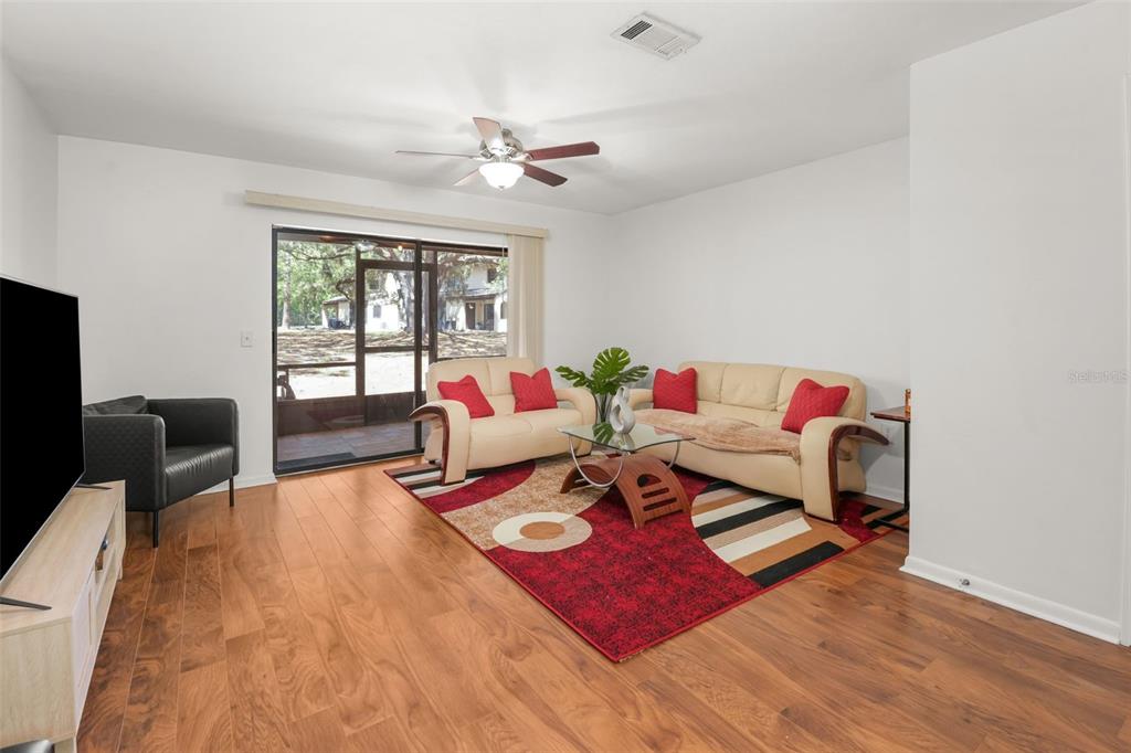 2735 Southwest 35th Place, Unit 903 Gainesville, FL 32608 - Photo 3 of 21 a living room with furniture and a flat screen tv