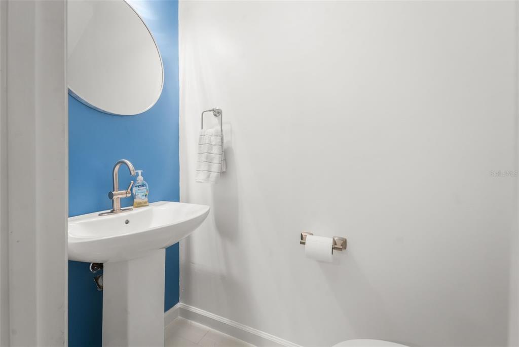 2735 Southwest 35th Place, Unit 903 Gainesville, FL 32608 - Photo 5 of 21 a bathroom with a sink and mirror