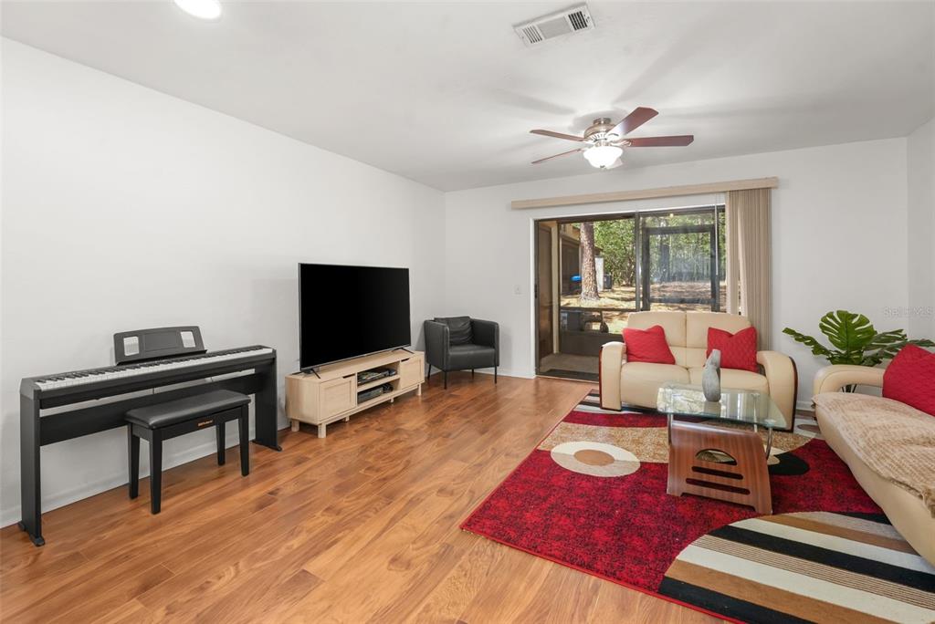 2735 Southwest 35th Place, Unit 903 Gainesville, FL 32608 - Photo 6 of 21 a living room with furniture and a flat screen tv
