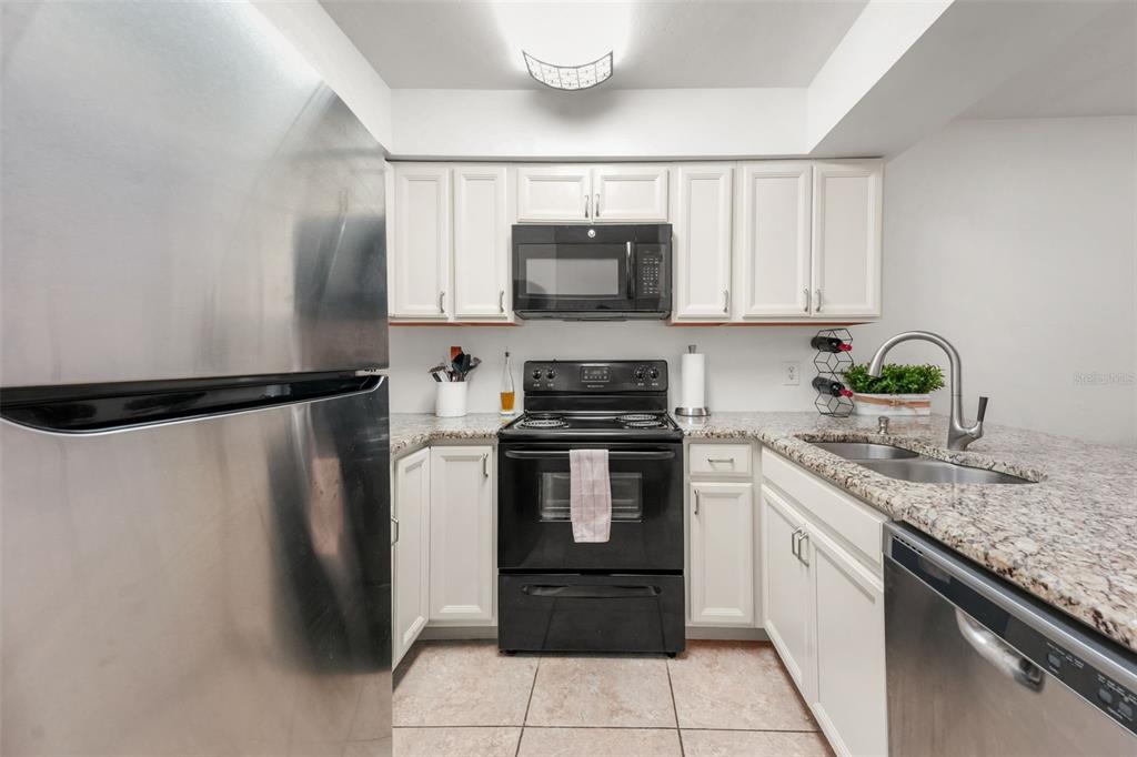 2735 Southwest 35th Place, Unit 903 Gainesville, FL 32608 - Photo 7 of 21 a kitchen with a sink stove and refrigerator