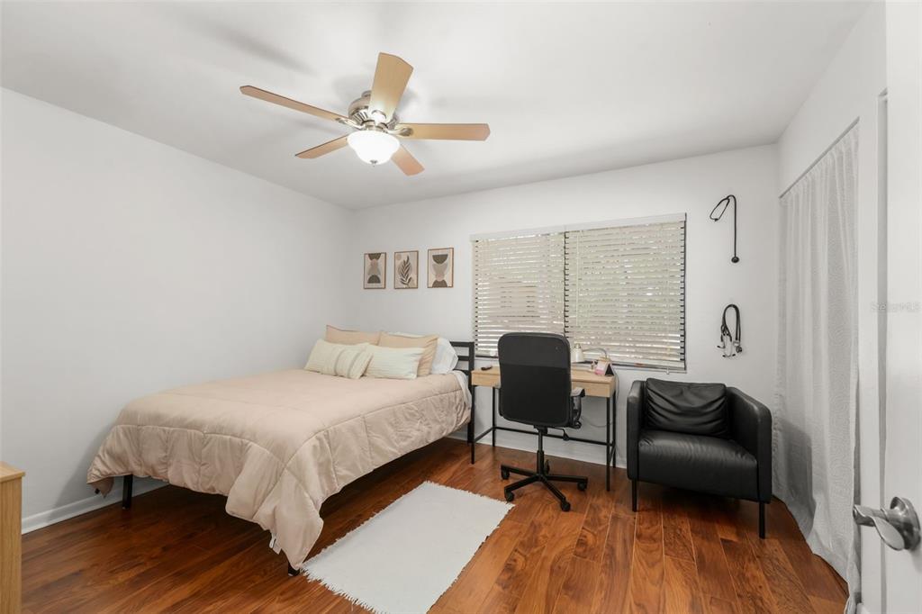 2735 Southwest 35th Place, Unit 903 Gainesville, FL 32608 - Photo 9 of 21 a bedroom with a bed and a chair