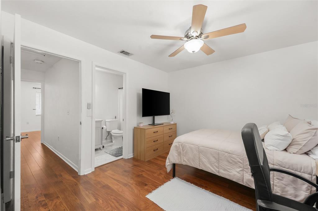2735 Southwest 35th Place, Unit 903 Gainesville, FL 32608 - Photo 10 of 21 a spacious bedroom with a bed and a flat screen tv