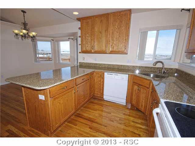 15028 Herring Road Colorado Springs, CO 80908 - Photo 4 of 17 BRAND NEW GRANITE COUNTERS! Hardwood flooring, smoothtop stove and dining nook just off the kitchen
