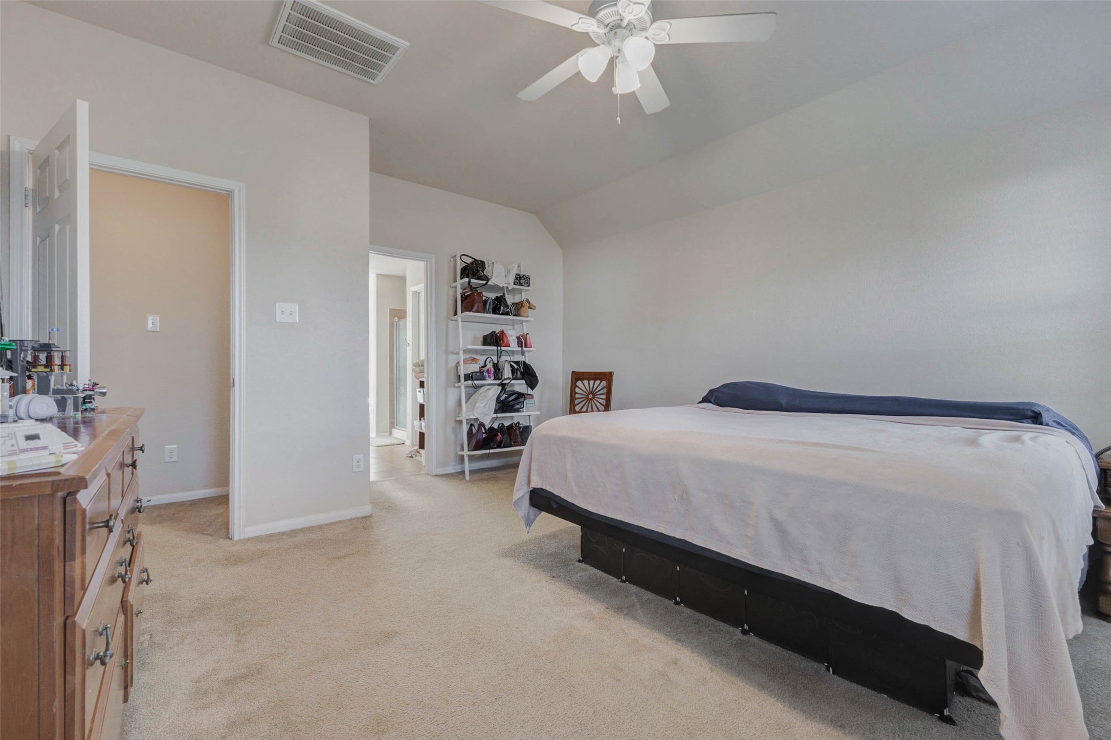 3027 Upland Spring Trace Katy, TX 77493 - Photo 17 of 29 a spacious bedroom with a bed and a chandelier