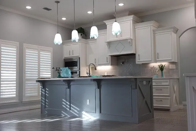 a kitchen with a sink cabinets and window