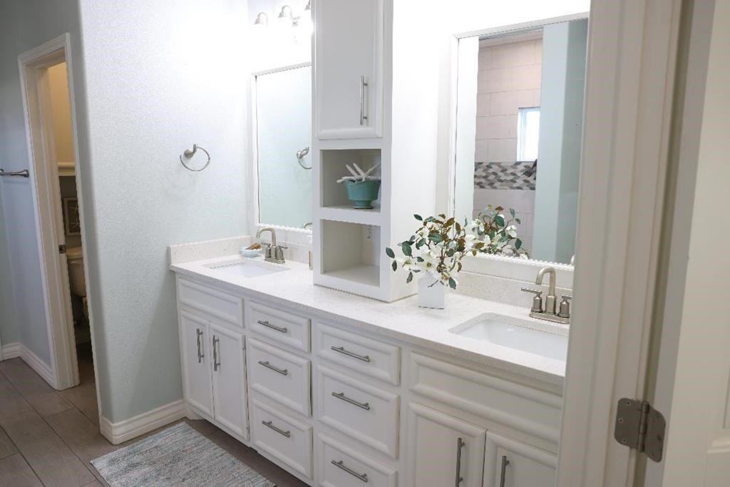 13 Southpointe Circle Rockport, TX 78382 - Photo 15 of 30 a bathroom with a double vanity sink and a mirror