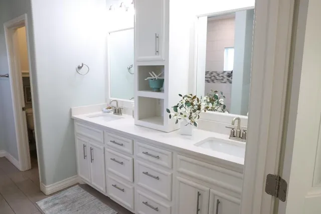 a bathroom with a double vanity sink and a mirror