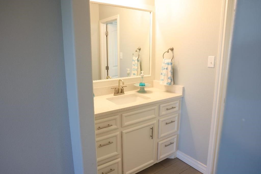 13 Southpointe Circle Rockport, TX 78382 - Photo 23 of 30 a bathroom with a double vanity sink and a mirror