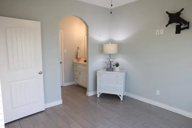 a view of a room with a hardwood and a mirror