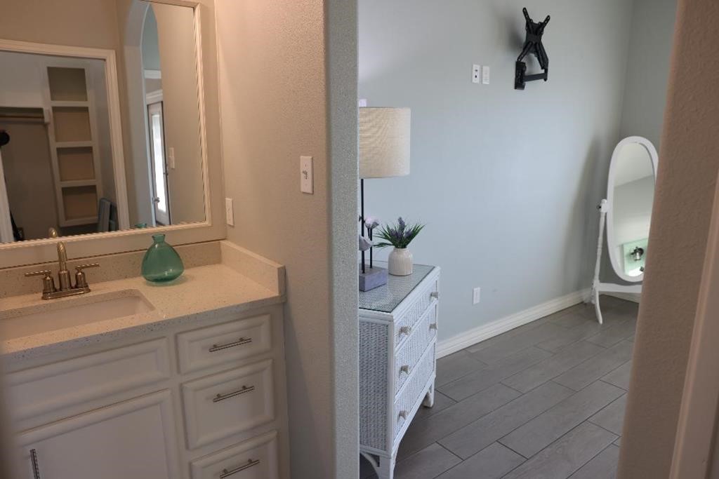 13 Southpointe Circle Rockport, TX 78382 - Photo 27 of 30 a en suite bathroom with a granite countertop sink and a mirror