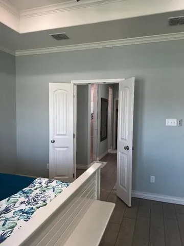 a bedroom with a bed and a hallway