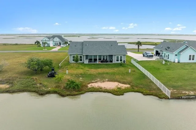 an aerial view of a house with yard swimming pool and outdoor seating