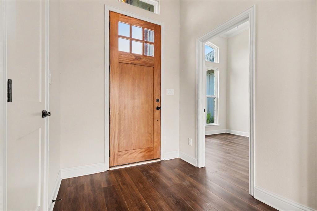530 P R 491 Leonard, TX 75452 - Photo 4 of 35 Entryway featuring a natural wood-finish door with multi-pane windows, a transom window, and dark wood-finish flooring