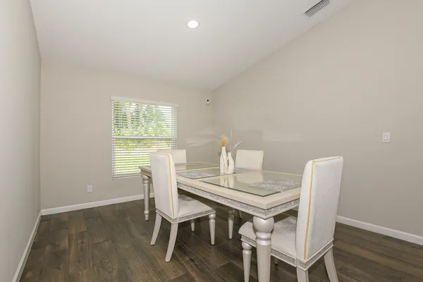 a view of a dining room with furniture and wooden floor