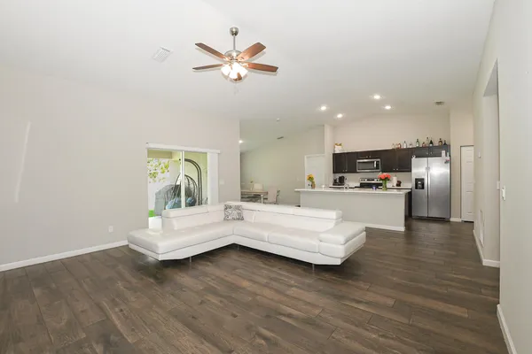 a living room with furniture and kitchen view