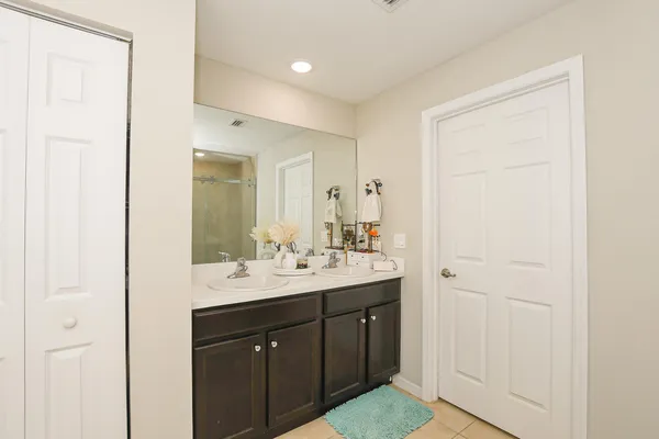 a bathroom with a sink a mirror and a shower