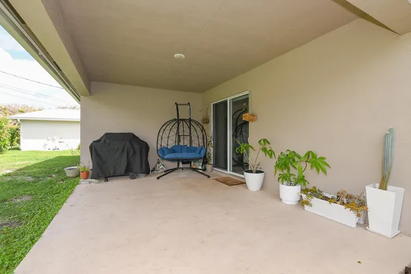 a view of a two chairs in a patio