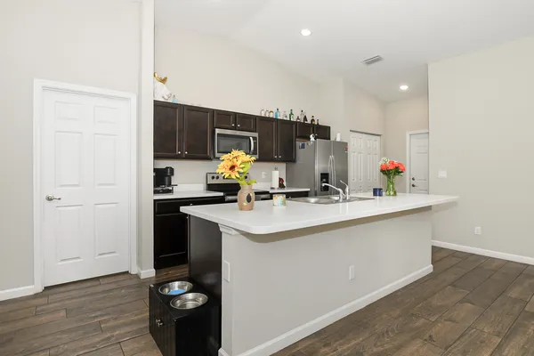 a kitchen with a sink cabinets and wooden floor