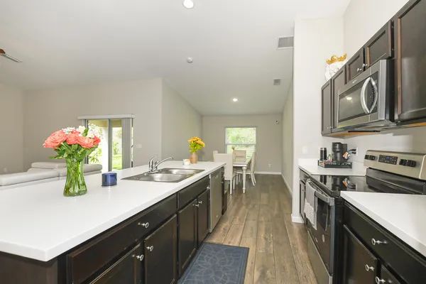 a kitchen with a sink stove and cabinets
