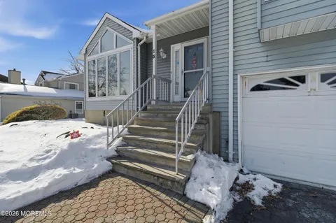 a view of a livingroom with furniture wooden floor and windows