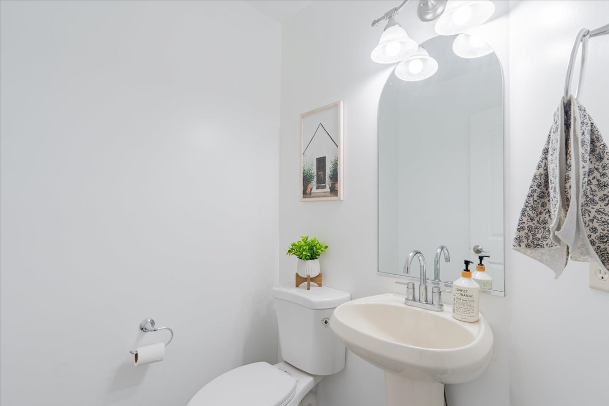 1236 Blue Bill Way Normal, IL 61761 - Photo 12 of 38 a bathroom with a sink a toilet and a mirror