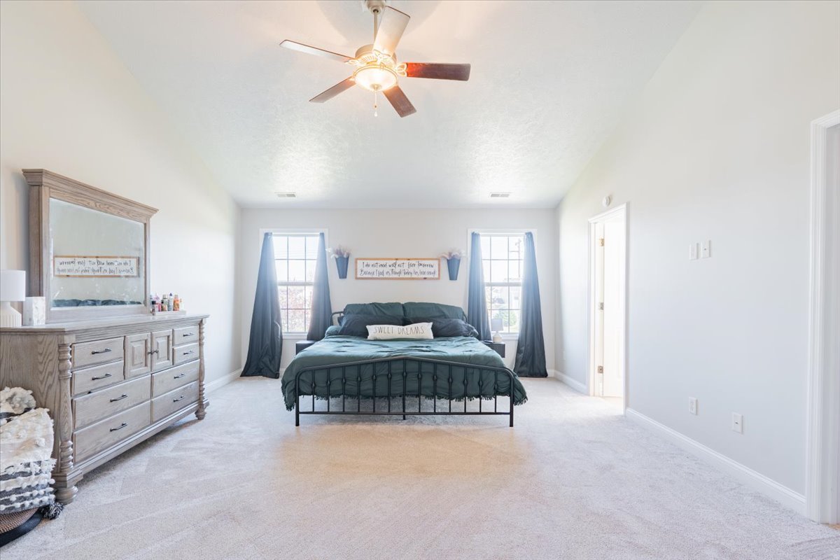 1236 Blue Bill Way Normal, IL 61761 - Photo 14 of 38 a bedroom with a large bed and a chandelier