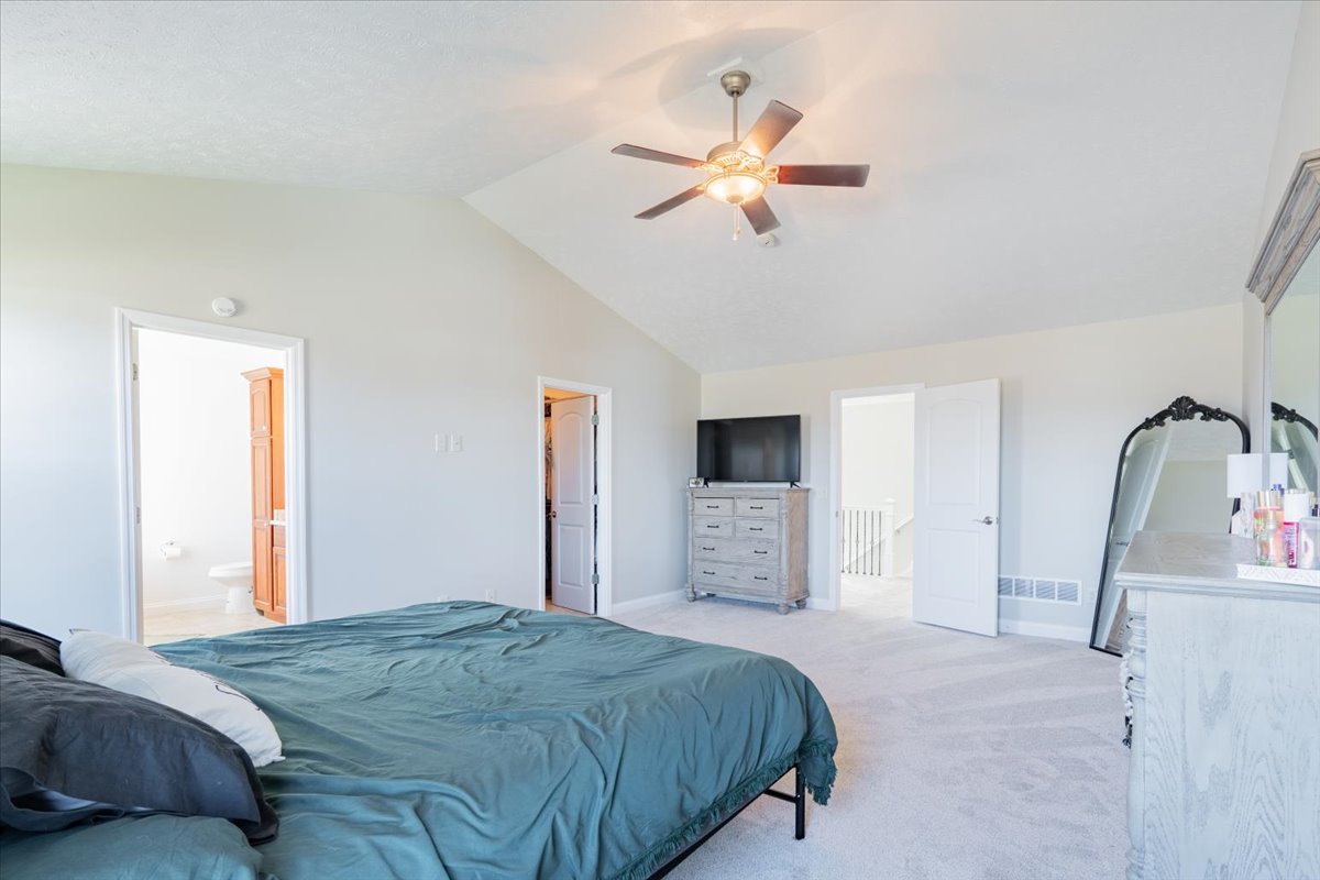 1236 Blue Bill Way Normal, IL 61761 - Photo 15 of 38 a bedroom with a bed and a chandelier