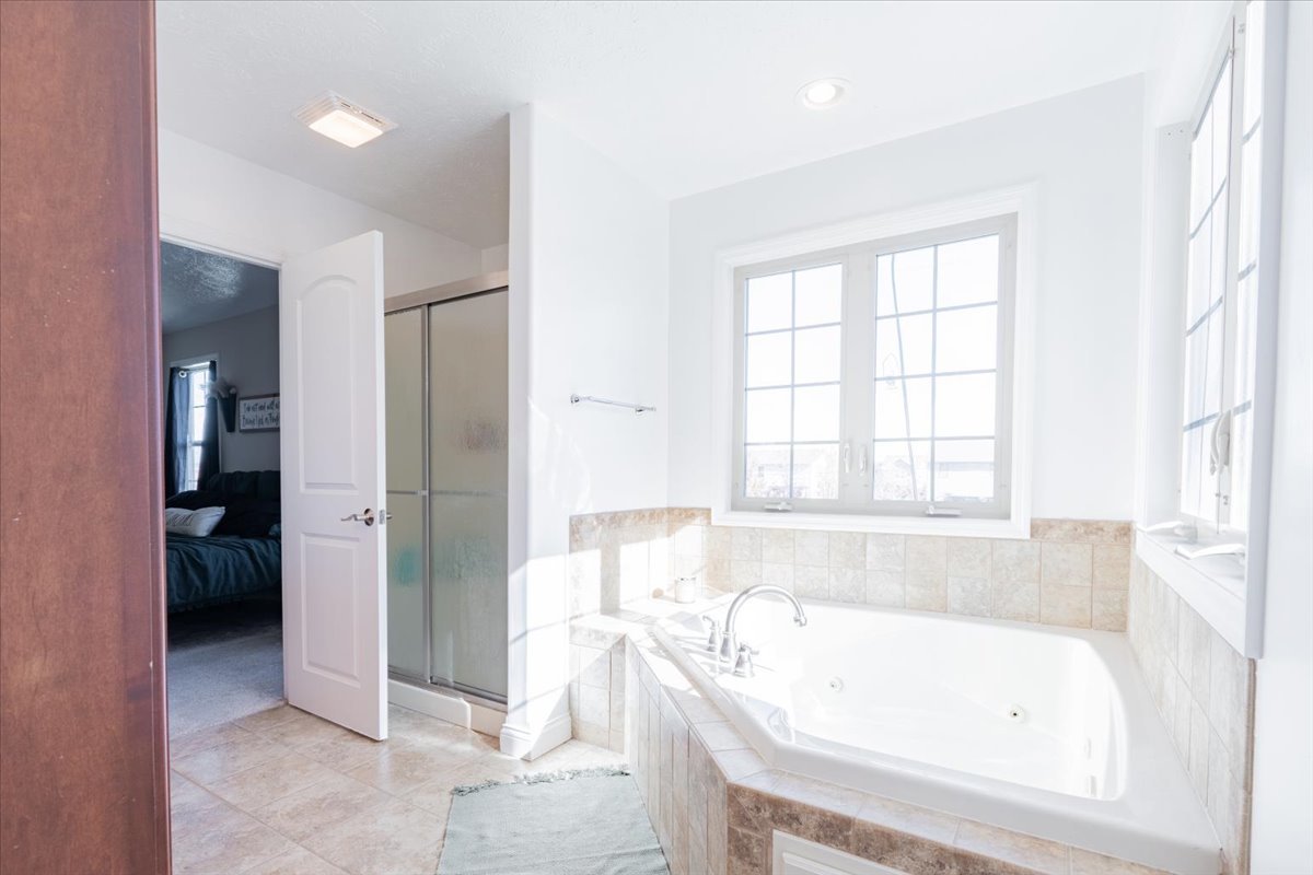 1236 Blue Bill Way Normal, IL 61761 - Photo 17 of 38 a bathroom with a bathtub and a shower