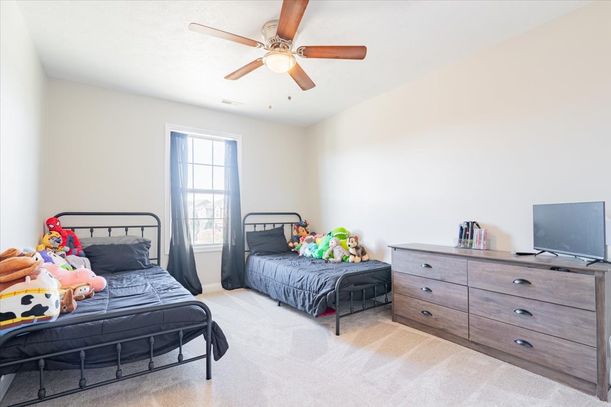 1236 Blue Bill Way Normal, IL 61761 - Photo 20 of 38 a bedroom with two beds and a chandelier