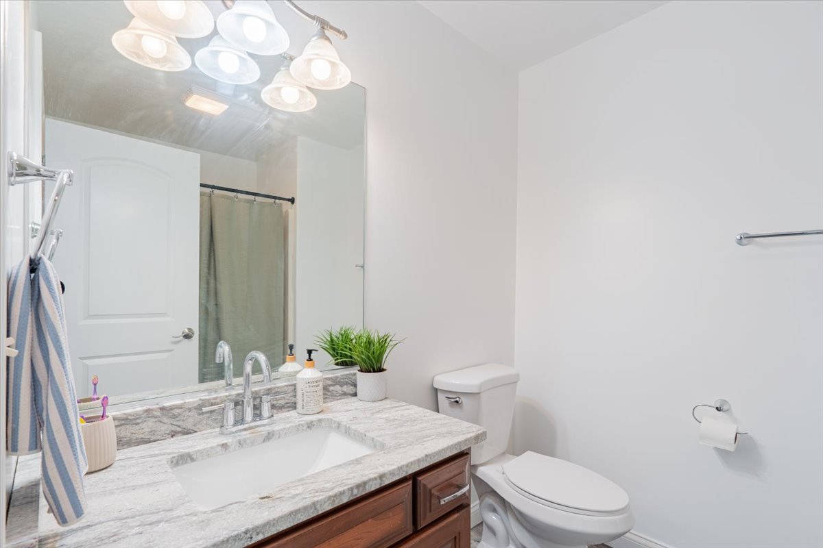 1236 Blue Bill Way Normal, IL 61761 - Photo 22 of 38 a bathroom with a granite countertop sink vanity mirror and toilet