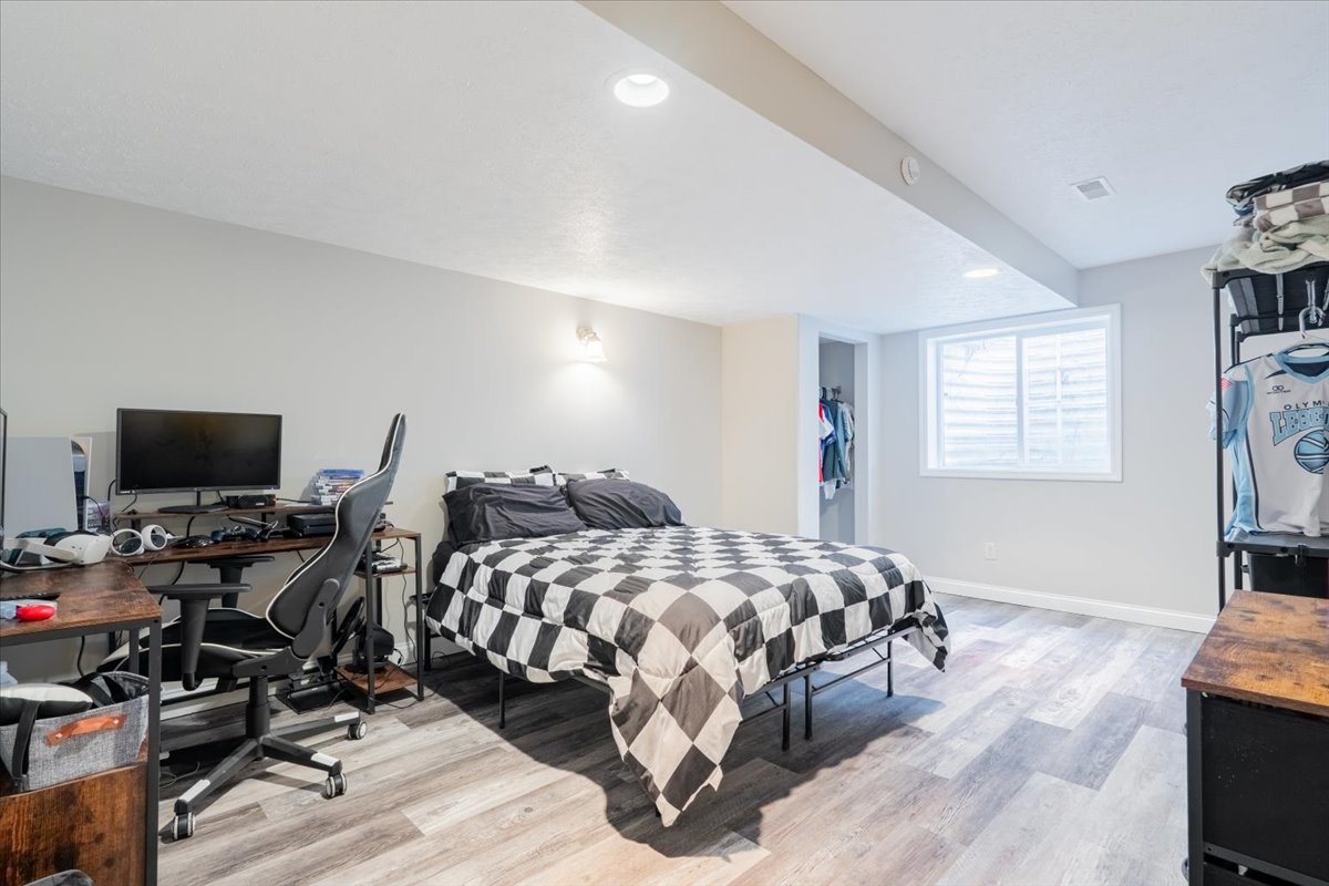 1236 Blue Bill Way Normal, IL 61761 - Photo 26 of 38 a bedroom with a bed a couch and a flat screen tv