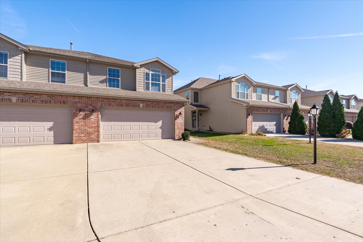 1236 Blue Bill Way Normal, IL 61761 - Photo 35 of 38 a front view of a house with a yard and garage