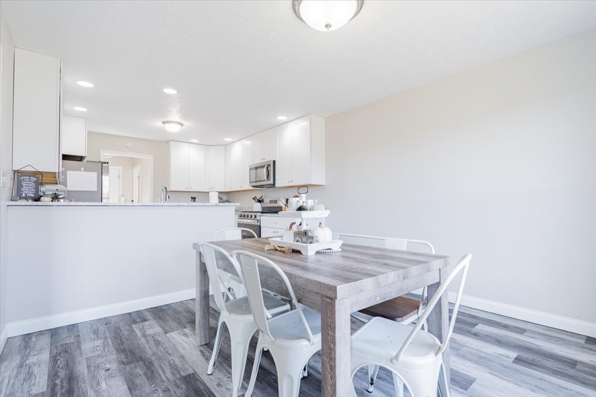 1236 Blue Bill Way Normal, IL 61761 - Photo 9 of 38 a view of a dining room with furniture and wooden floor