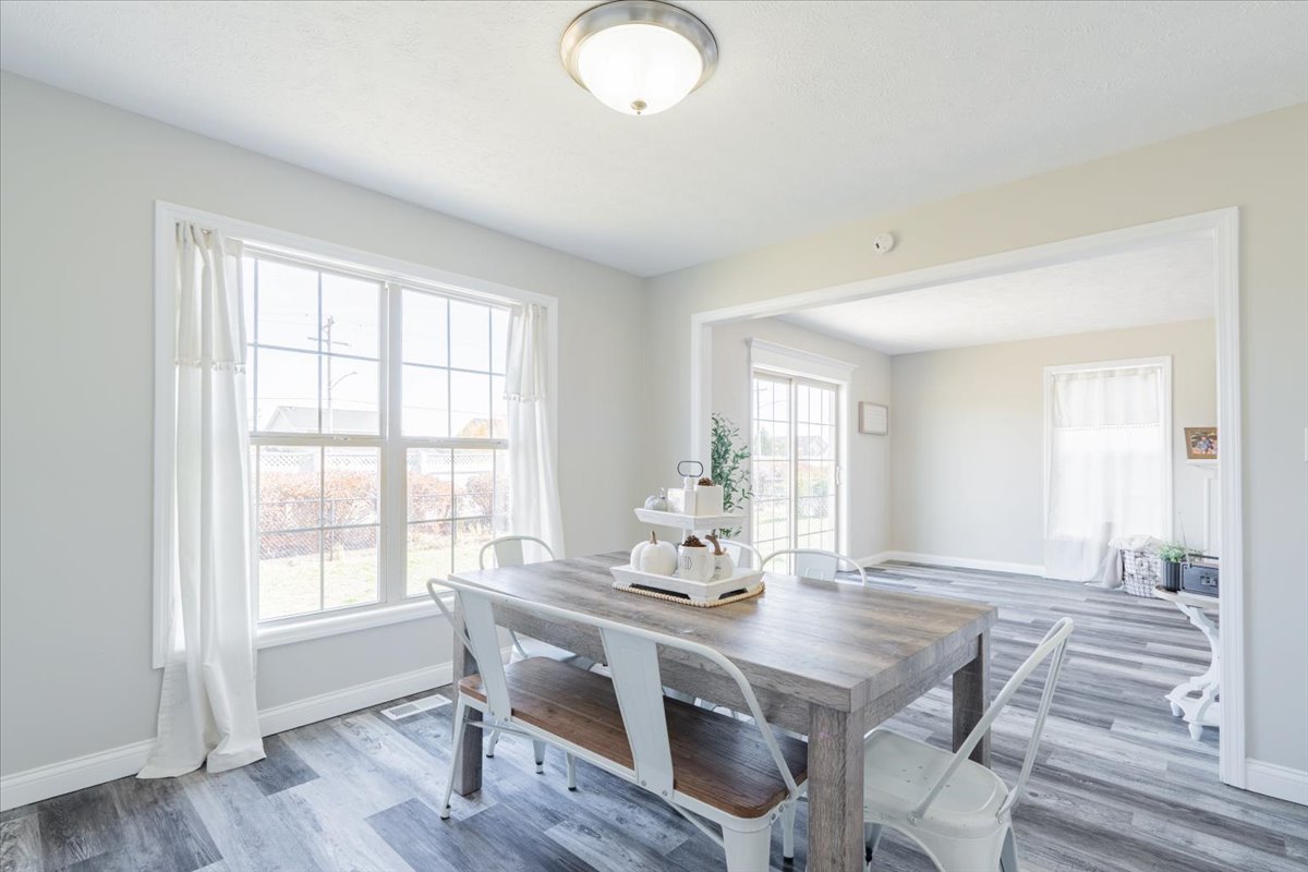 1236 Blue Bill Way Normal, IL 61761 - Photo 10 of 38 a view of a dining room with furniture window and wooden floor
