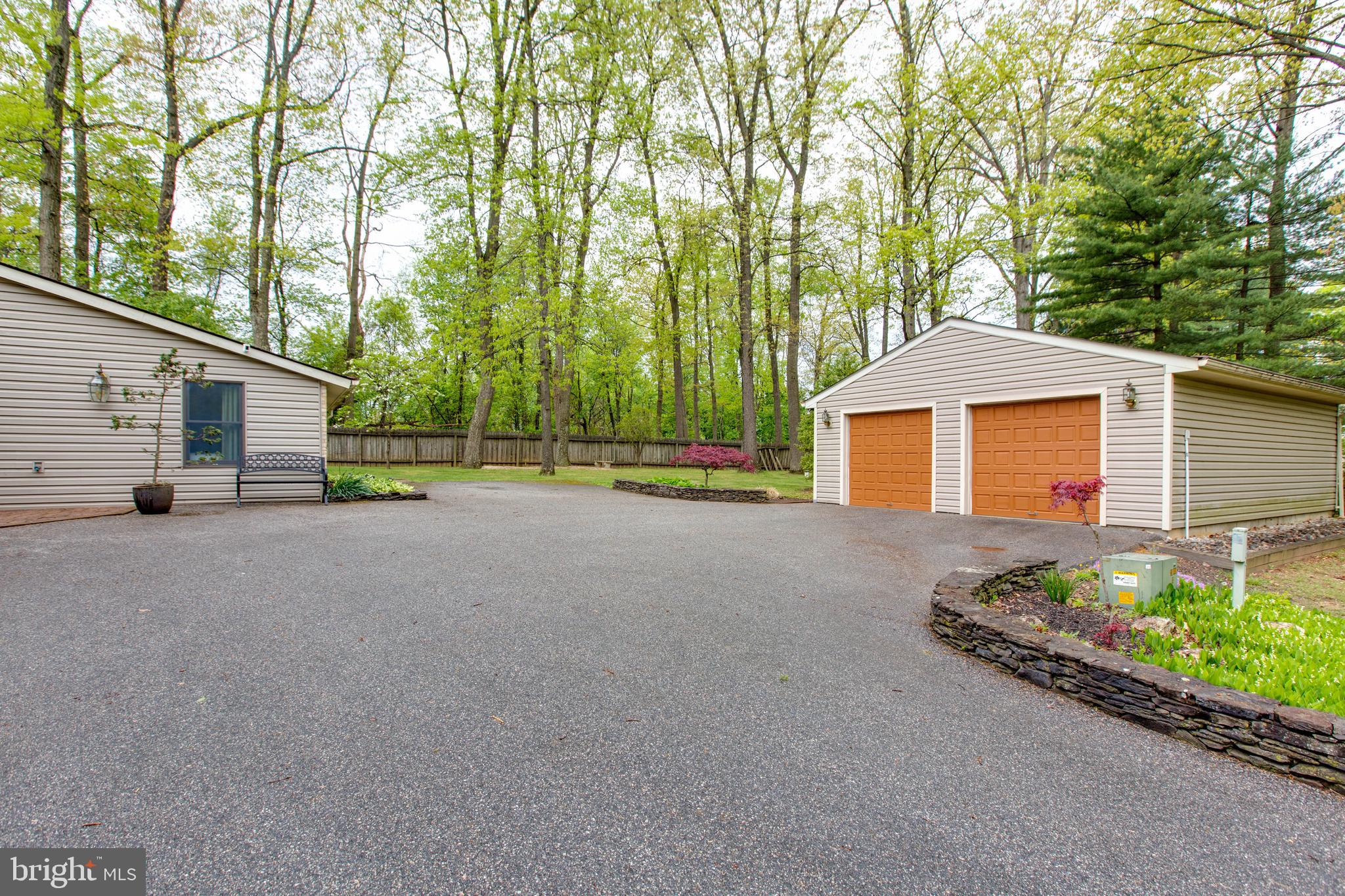 5519 Woodbine Road Sykesville, MD 21784 - Photo 5 of 69 a view of a house with a backyard and a garage