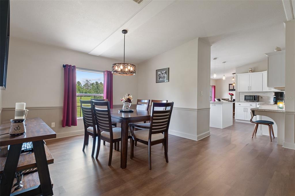26255 Lambeth Road Brooksville, FL 34601 - Photo 17 of 76 a view of a dining room with furniture and wooden floor