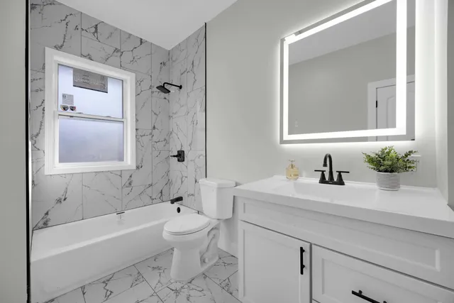 a bathroom with a sink a toilet and a bathtub