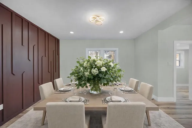 a dining room with furniture and a potted plant