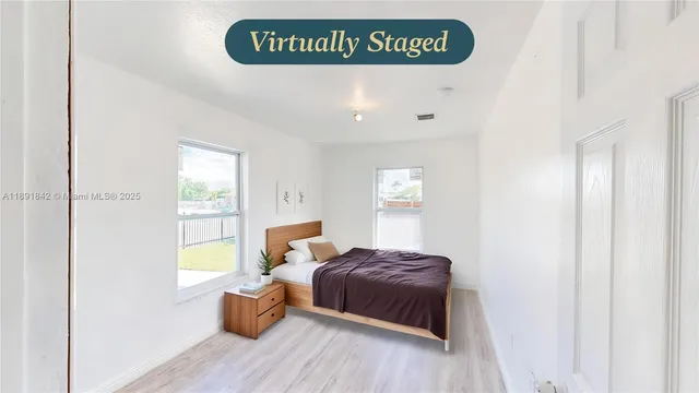 a view of bedroom with furniture and wooden floor
