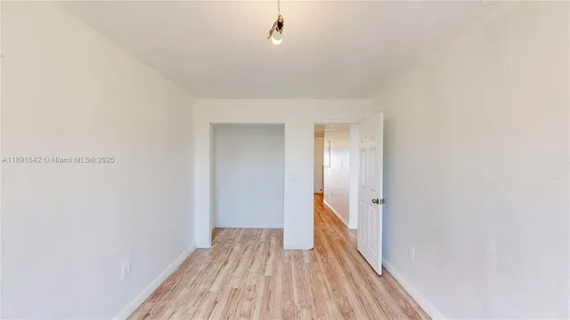 a view of a room with wooden floor