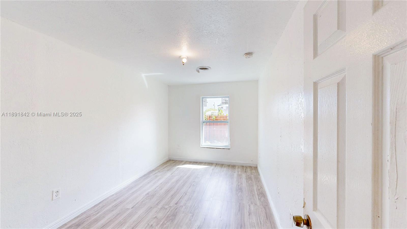 22230 Southwest 115th Court Miami, FL 33170 - Photo 17 of 63 a view of empty room with wooden floor and fan