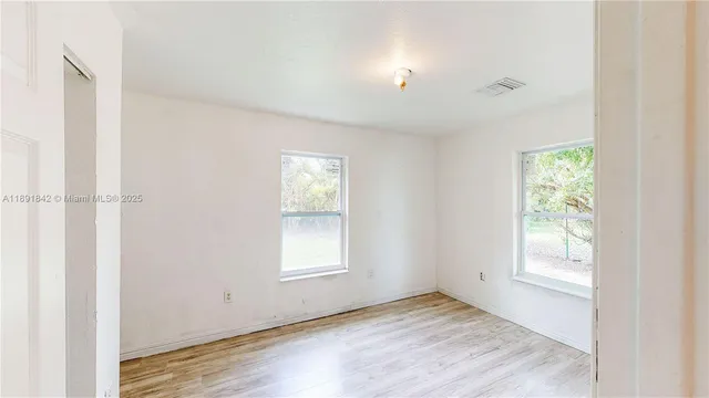 a bedroom with bed and window