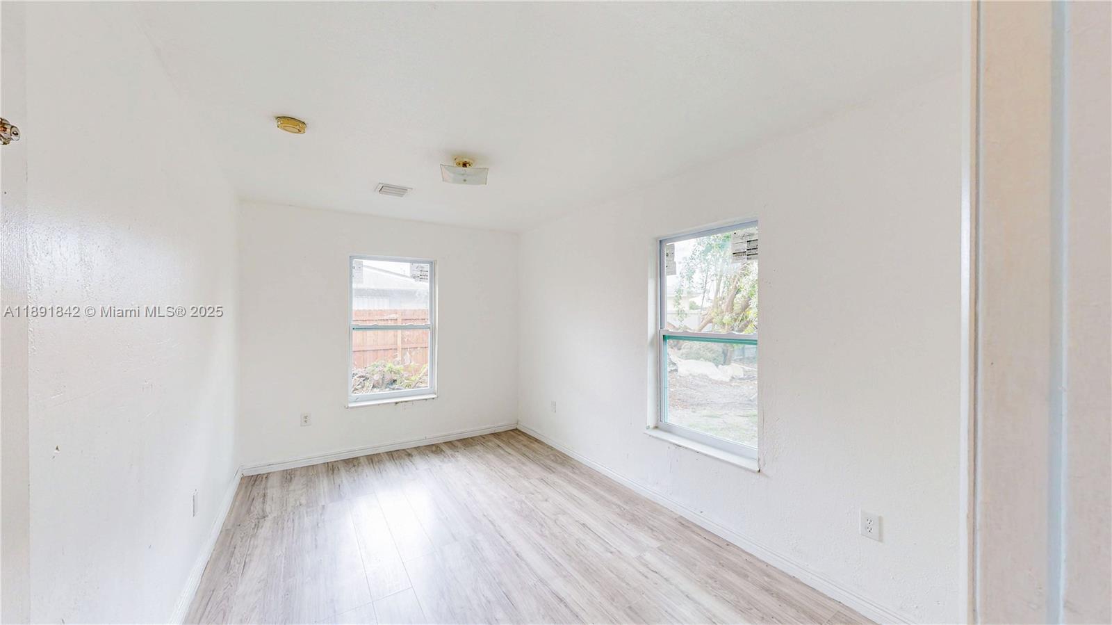 22230 Southwest 115th Court Miami, FL 33170 - Photo 24 of 63 a view of empty room with wooden floor and fan