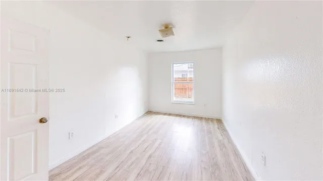 a living room with furniture and floor to ceiling window