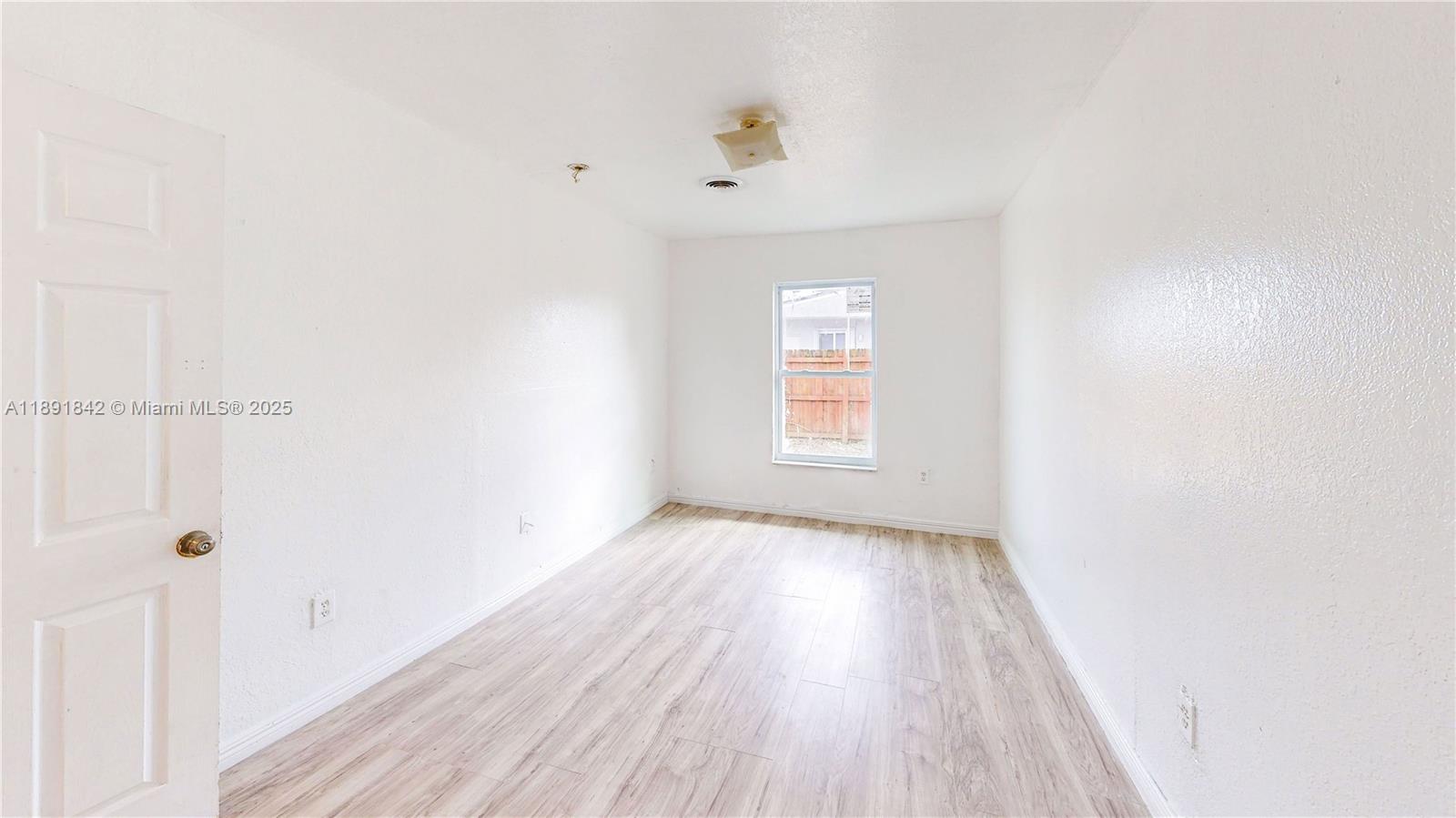 22230 Southwest 115th Court Miami, FL 33170 - Photo 36 of 63 a view of a hallway with wooden floor and a window