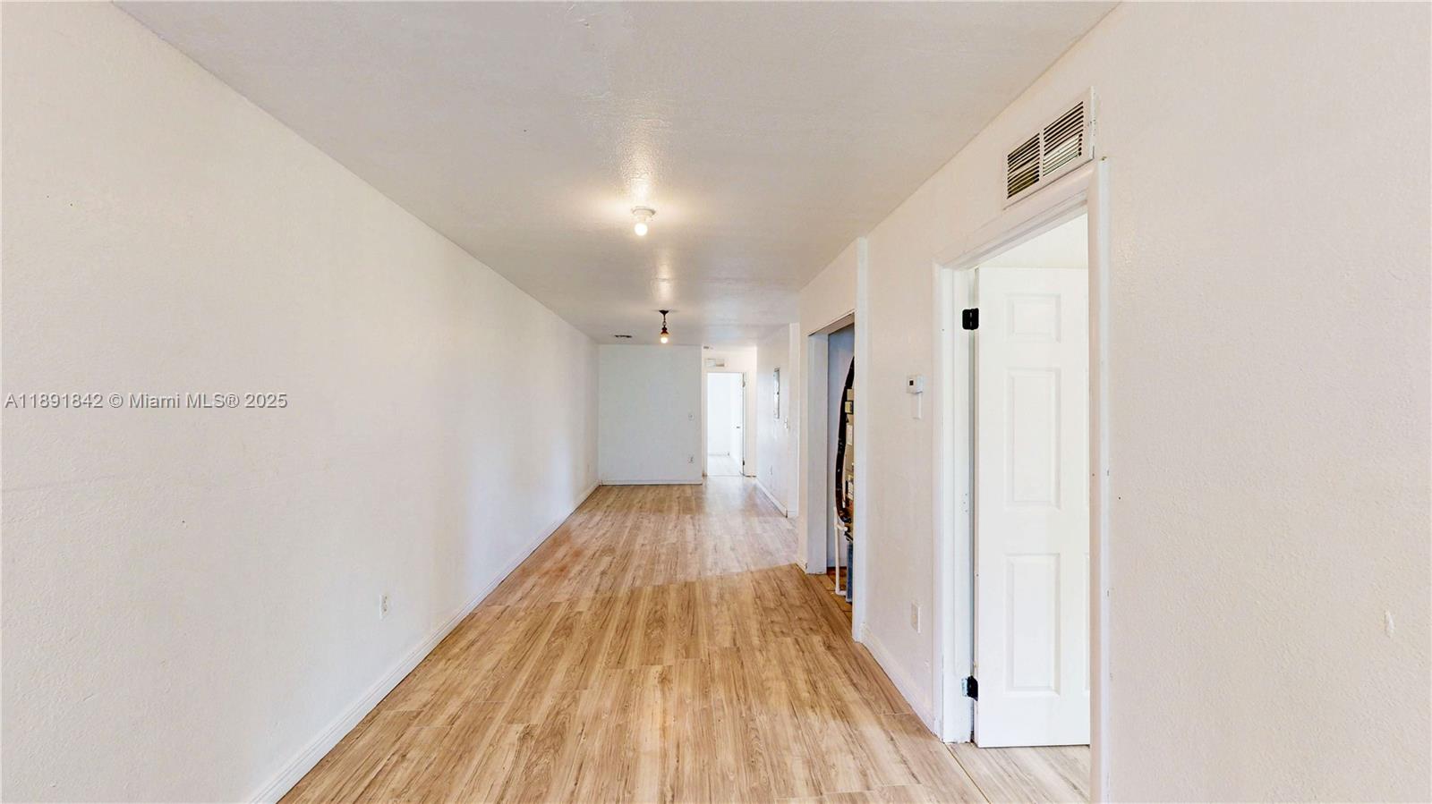 22230 Southwest 115th Court Miami, FL 33170 - Photo 38 of 63 a view of a hallway with wooden floor