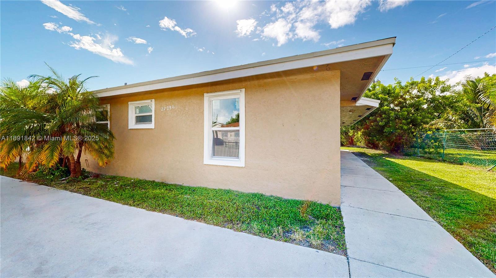 22230 Southwest 115th Court Miami, FL 33170 - Photo 46 of 63 a front view of a house with a yard and a garage