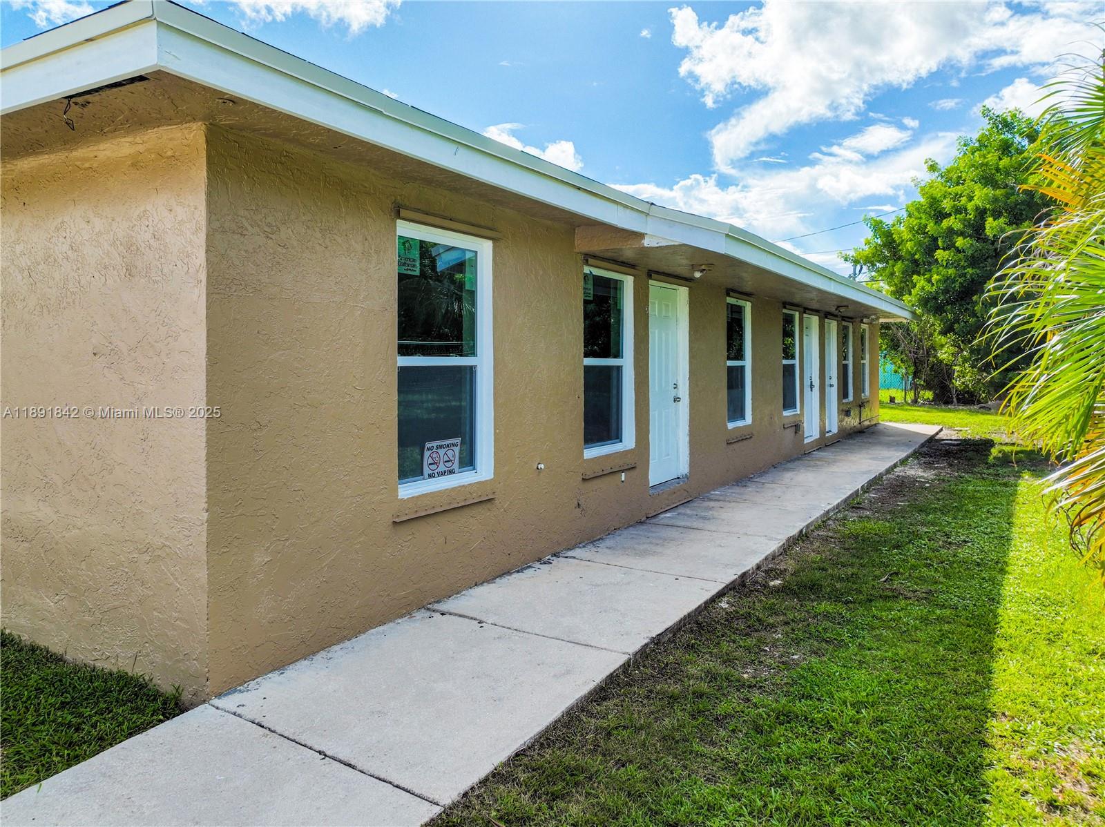 22230 Southwest 115th Court Miami, FL 33170 - Photo 51 of 63 a front view of a house with a yard