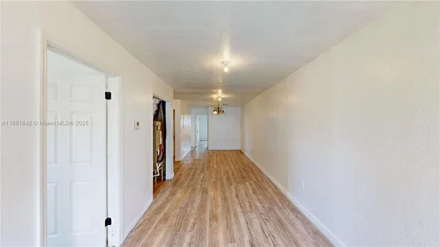 a view of hallway with wooden floor
